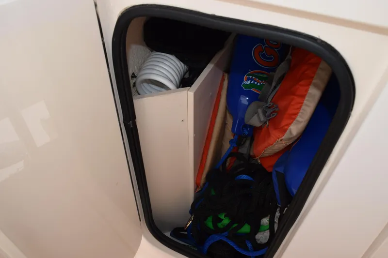 Slide: The Image of Storage compartment on a 2010 Grady-White Fisherman 209 boat with life jackets and gear. - 15