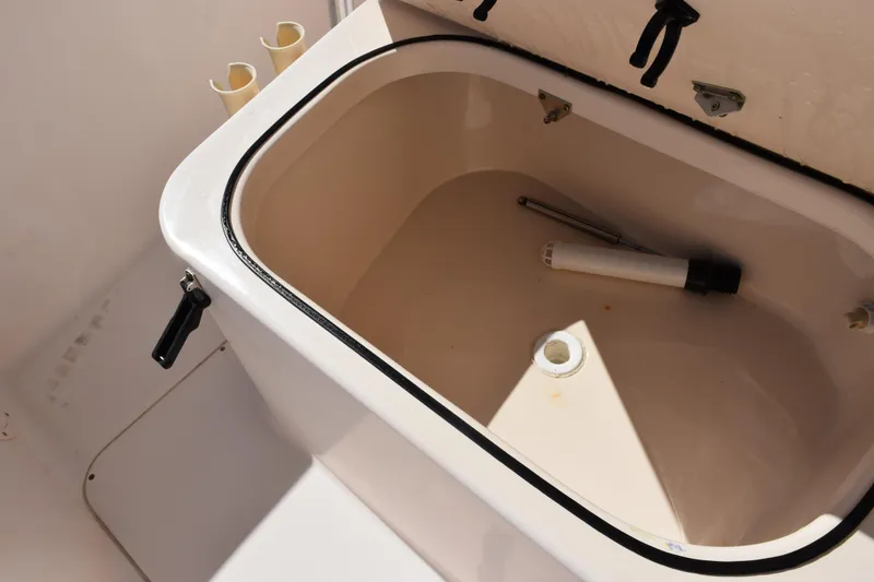 Slide: The Image of Open storage compartment on 2010 Grady-White Fisherman 209 boat, showing interior details. - 17