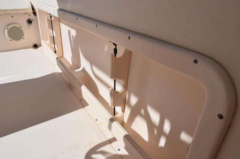 Slide: The Image of 2010 Grady-White Fisherman 209 boat interior, featuring rod holders and speaker. - 18