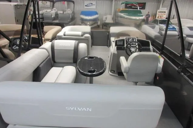 Slide: The Image of 2026 Sylvan Mirage 822 CLZ pontoon boat interior with plush seating and modern helm. - 10
