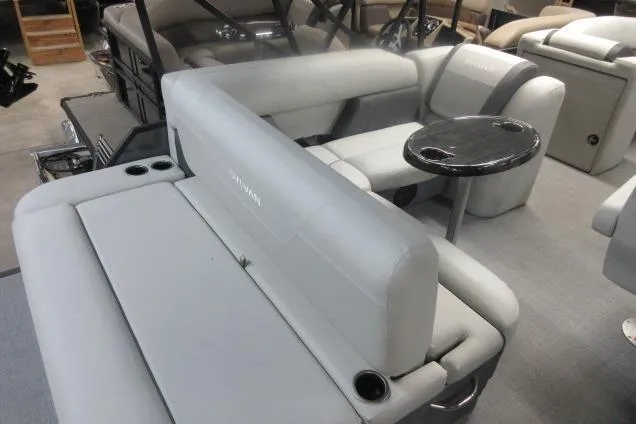 Slide: The Image of 2026 Sylvan Mirage 822 CLZ pontoon boat interior with plush seating and a small table. - 7
