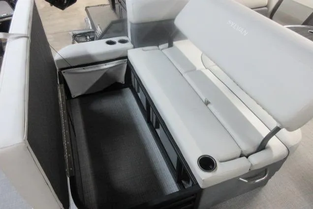 Slide: The Image of 2026 Sylvan Mirage 822 CLZ boat interior with white seating and storage compartment. - 9