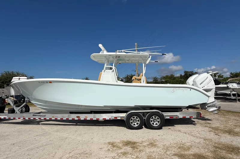 The Image of 2018 Yellowfin 32 Offshore boat on trailer under clear blue sky. - 0
