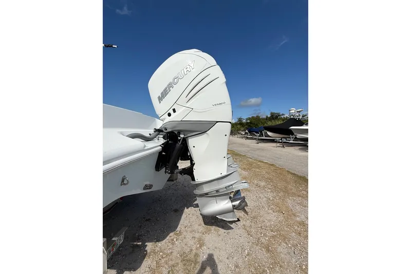 Slide: The Image of 2018 Yellowfin 32 Offshore with Mercury Verado outboard engine, parked on gravel. - 10