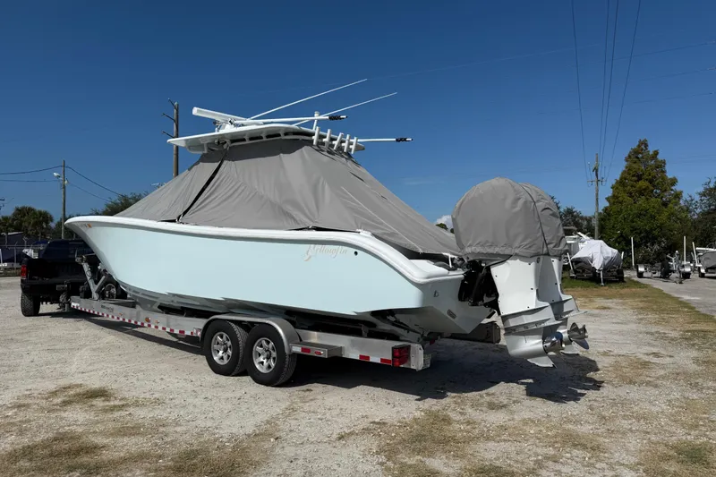 Slide: The Image of 2018 Yellowfin 32 Offshore boat on trailer, covered, parked outdoors. - 106
