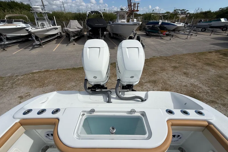 Slide: The Image of 2018 Yellowfin 32 Offshore boat with dual outboard motors in a marina. - 13