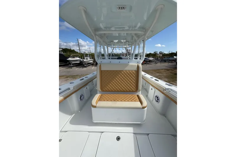 Slide: The Image of 2018 Yellowfin 32 Offshore boat interior with tan quilted seating and spacious deck. - 16