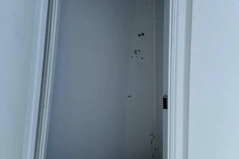 Slide: The Image of Empty white closet with dirt marks on the wall. - 27