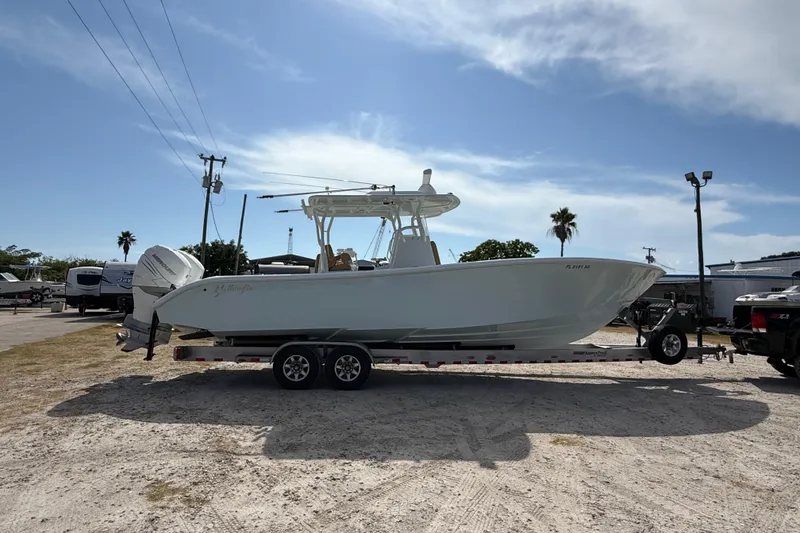 Slide: The Image of 2018 Yellowfin 32 Offshore boat on trailer under clear sky. - 3
