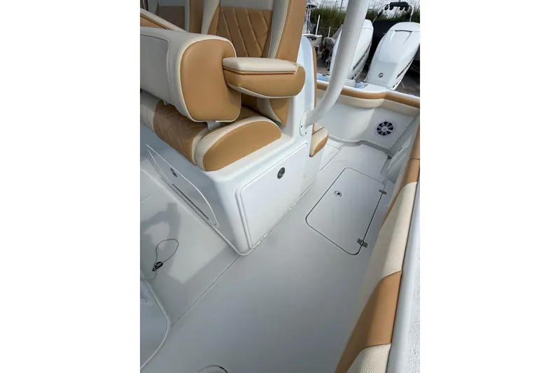 Slide: The Image of 2018 Yellowfin 32 Offshore boat interior with tan and white seating. - 67