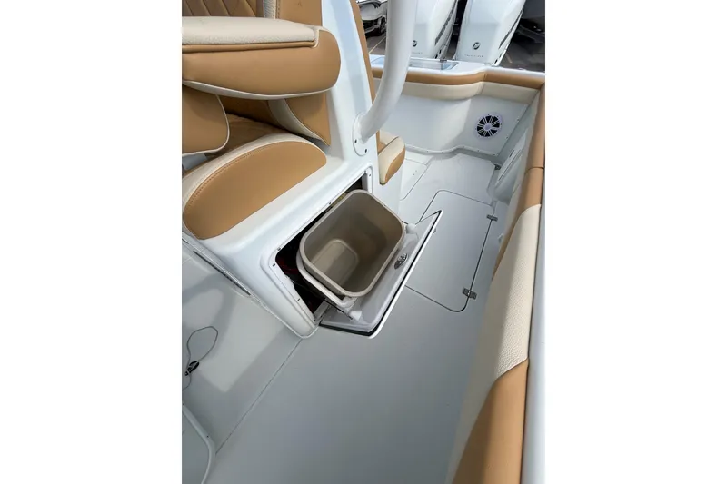 Slide: The Image of 2018 Yellowfin 32 Offshore boat interior with tan seating and storage compartment. - 68