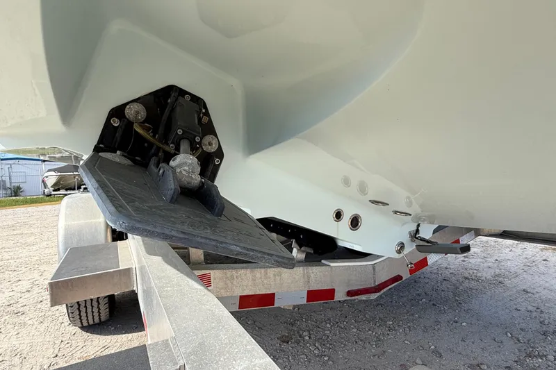 Slide: The Image of 2018 Yellowfin 32 Offshore boat on trailer, showing trim tab and hull details. - 7