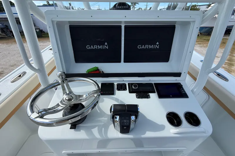 Slide: The Image of 2018 Yellowfin 32 Offshore boat console with Garmin displays and steering wheel. - 74