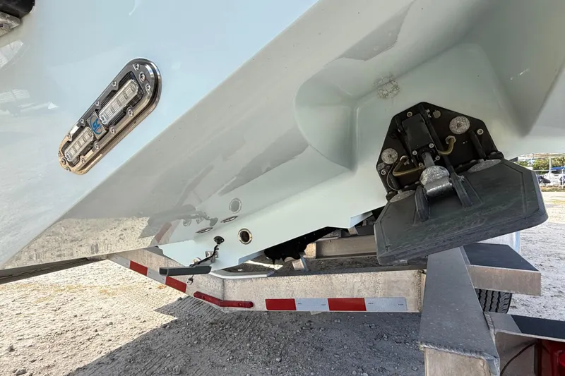 Slide: The Image of 2018 Yellowfin 32 Offshore boat on trailer, showing hull and trim tab details. - 8