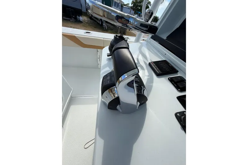 Slide: The Image of 2018 Yellowfin 32 Offshore boat throttle controls and dashboard. - 80