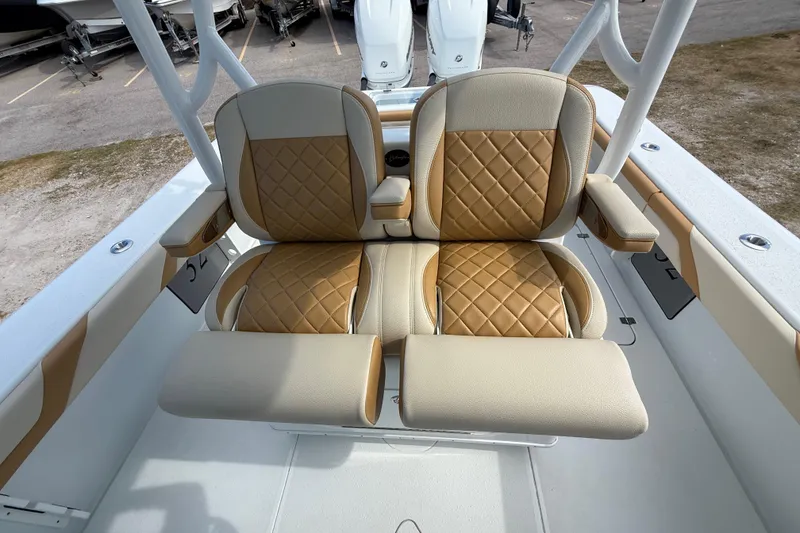 Slide: The Image of 2018 Yellowfin 32 Offshore boat with tan and beige cushioned seating. - 84