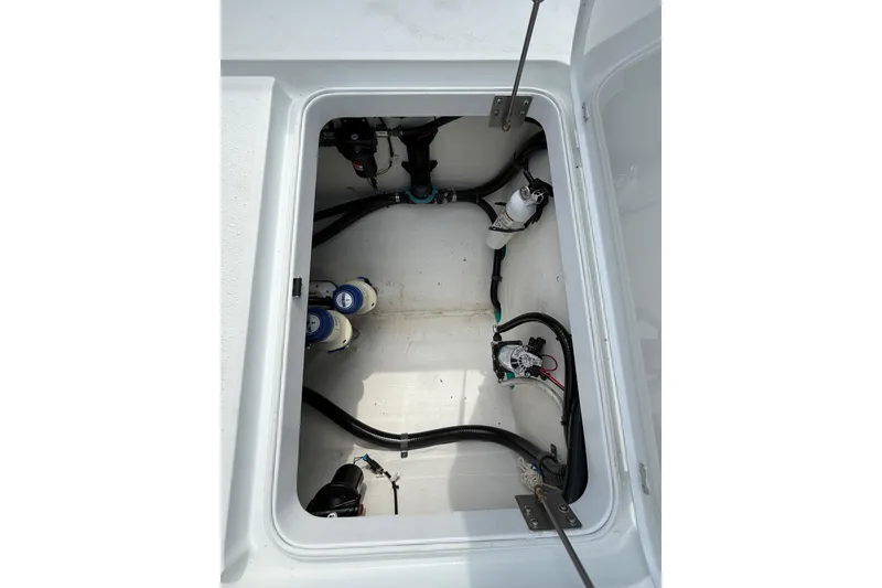 Slide: The Image of 2018 Yellowfin 32 Offshore boat compartment with wiring and components. - 87