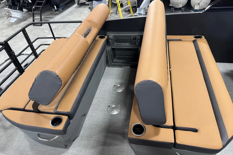 Slide: The Image of 2026 Sylvan L5 DLZ Platinum boat interior with tan seating and cup holders. - 12