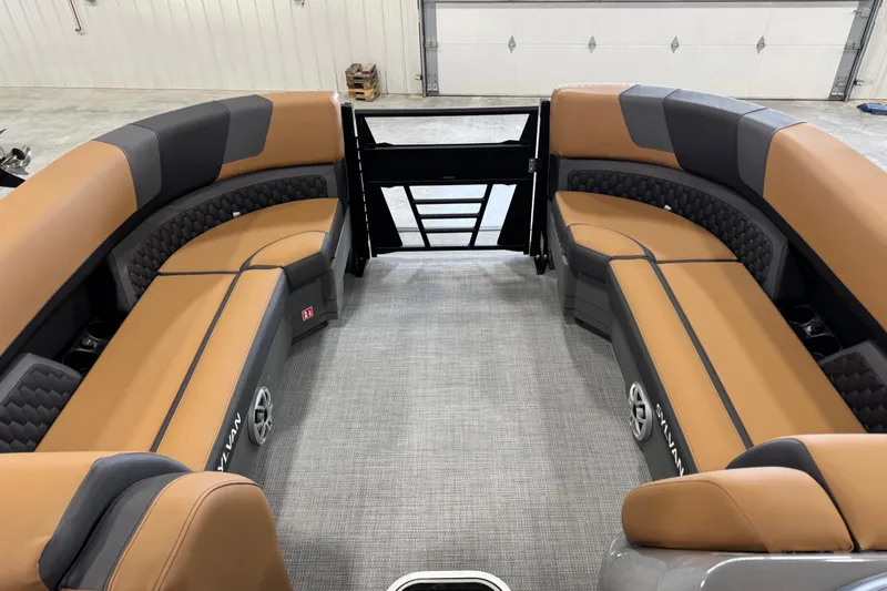 Slide: The Image of 2026 Sylvan L5 DLZ Platinum pontoon boat interior with tan and gray seating. - 15