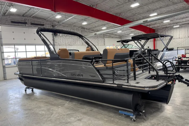 Slide: The Image of 2026 Sylvan L5 DLZ Platinum pontoon boat in showroom, featuring sleek design and modern seating. - 5