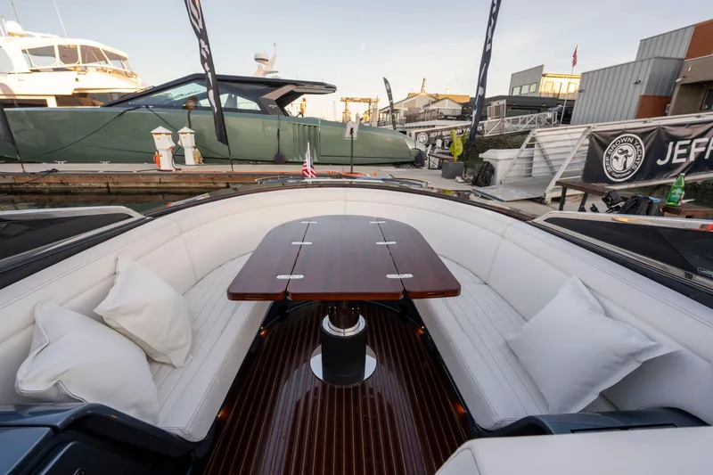 Slide: The Image of Luxurious 2026 Riva 33' Aquariva Special yacht interior with elegant seating and wooden table. - 19