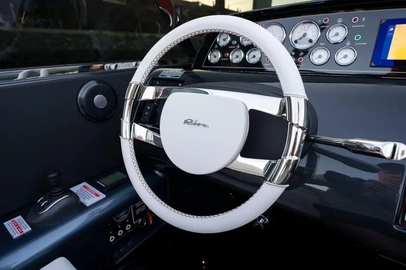 Slide: The Image of Steering wheel of 2026 Riva 33' Aquariva Special with sleek dashboard design. - 26