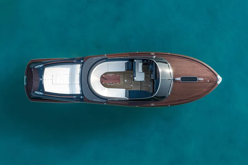 Slide: The Image of 2026 Riva 33 Aquariva Special luxury yacht on clear blue water, top view. - 6