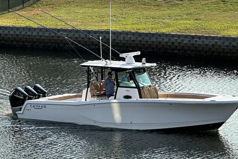 The Image of 2023 Caymas 341 CC boat cruising on a calm waterway. - 0