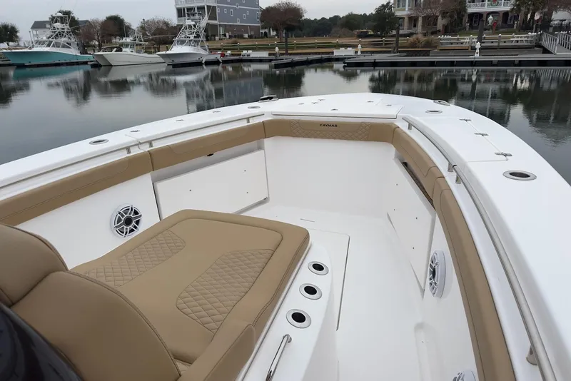 Slide: The Image of 2023 Caymas 341 CC boat interior with tan seating, docked at marina. - 10