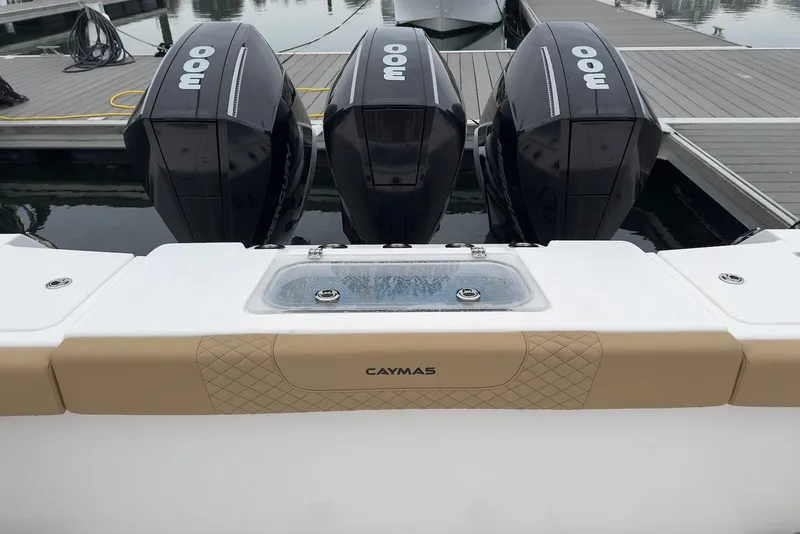 Slide: The Image of 2023 Caymas 341 CC boat with triple outboard engines at dock. - 13