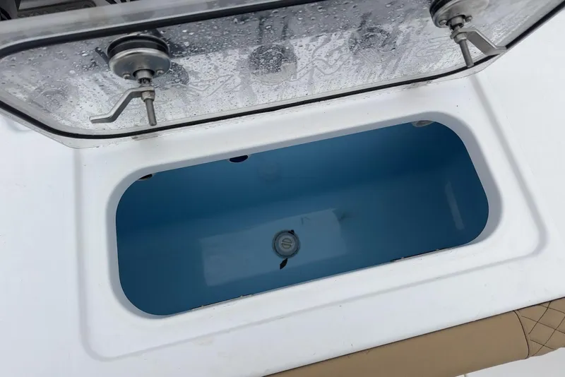 Slide: The Image of Livewell compartment on 2023 Caymas 341 CC boat, featuring a clear lid and secure latches. - 15