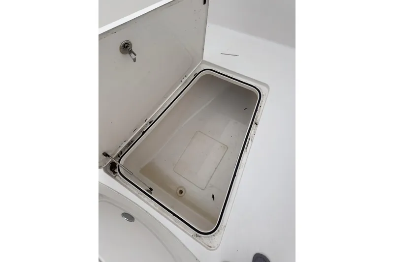 Slide: The Image of Open storage compartment on 2023 Caymas 341 CC boat. - 16