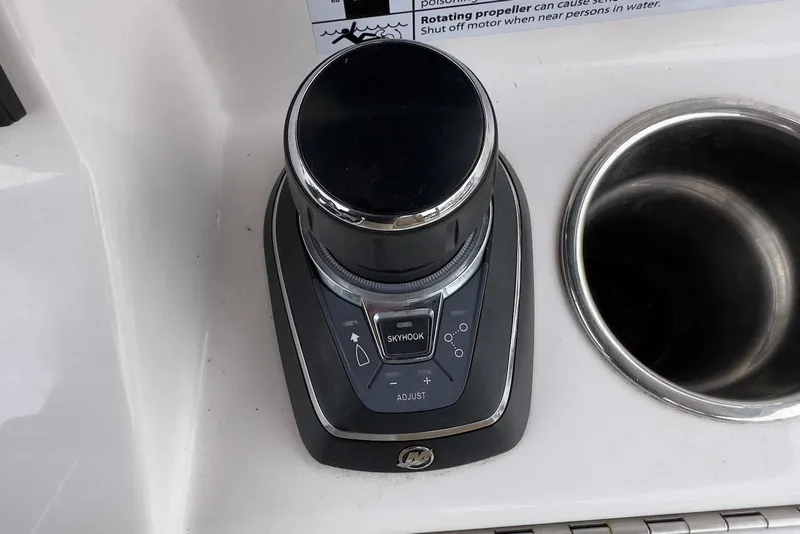 Slide: The Image of 2023 Caymas 341 CC boat control panel with joystick and cup holder. - 19
