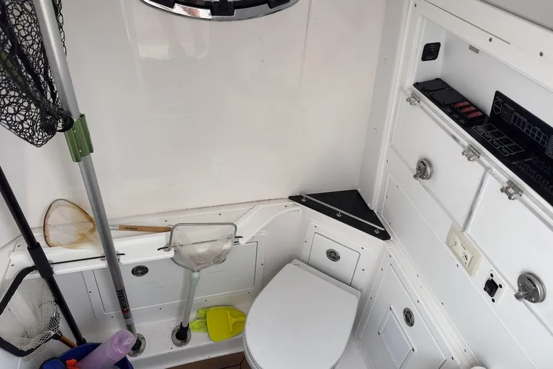 Slide: The Image of 2023 Caymas 341 CC boat interior with fishing gear and storage compartments. - 23