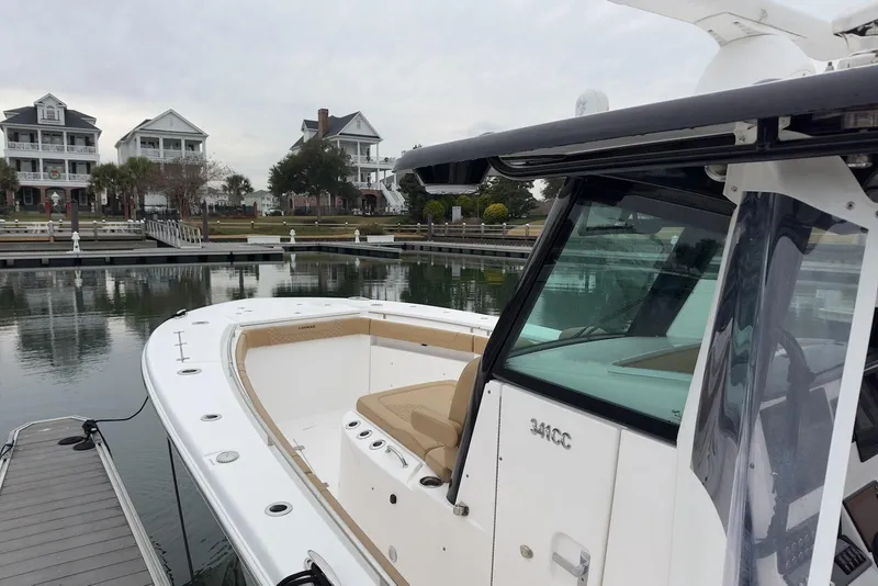 Slide: The Image of 2023 Caymas 341 CC boat docked near waterfront homes. - 7