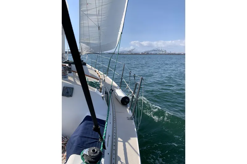 Slide: The Image of Sailing on 1988 Catalina MKll yacht with view of harbor and clear blue sky. - 10
