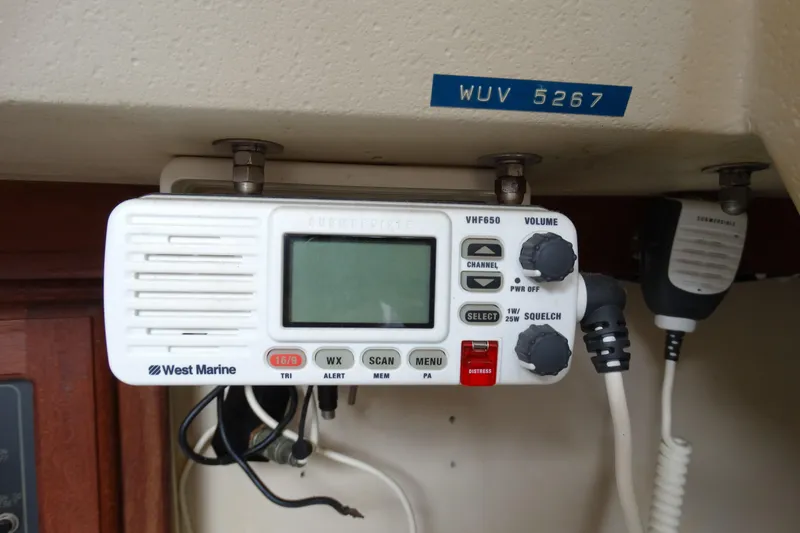 Slide: The Image of VHF marine radio on 1988 Catalina MKll boat, featuring West Marine branding. - 17