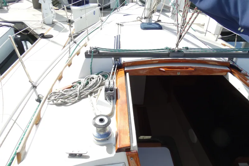 Slide: The Image of 1988 Catalina MKll sailboat deck with ropes and winch, docked at marina. - 29