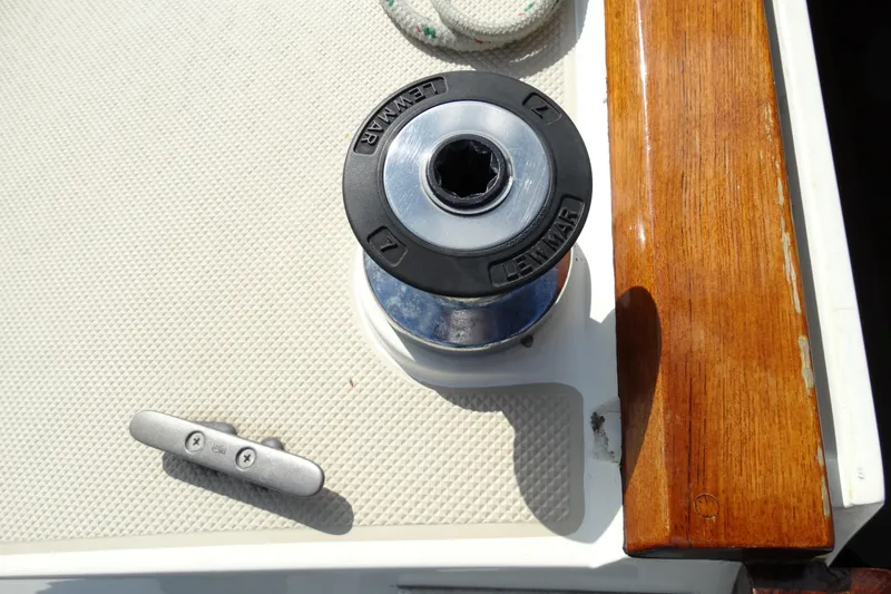 Slide: The Image of Winch and cleat on 1988 Catalina MKII sailboat deck, featuring wood trim. - 30