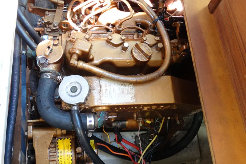 Slide: The Image of Engine compartment of a 1988 Catalina MKll sailboat, showcasing detailed mechanical components. - 36
