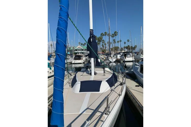Slide: The Image of 1988 Catalina 30 MkII sailboat docked in a marina with clear blue skies. - 5