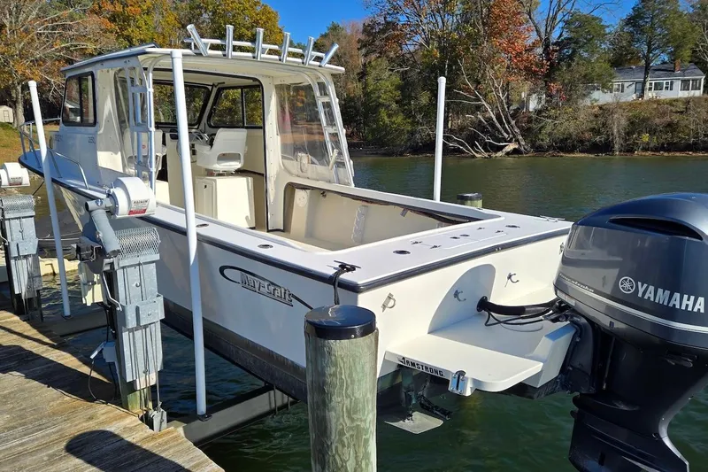 Slide: The Image of 2015 May-Craft 2550 Pilot XL boat docked with Yamaha outboard motor. - 12