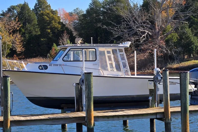 Slide: The Image of 2015 May-Craft 2550 Pilot XL boat docked on a sunny day. - 3