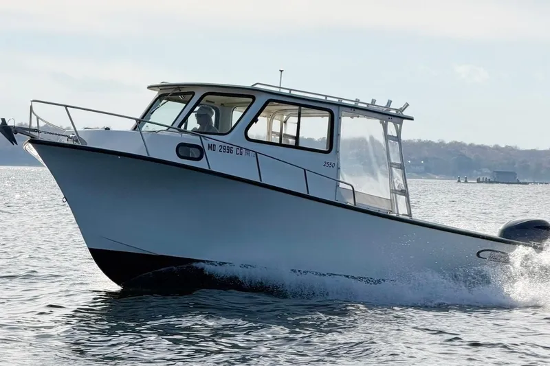 Slide: The Image of 2015 May-Craft 2550 Pilot XL boat cruising on open water. - 6