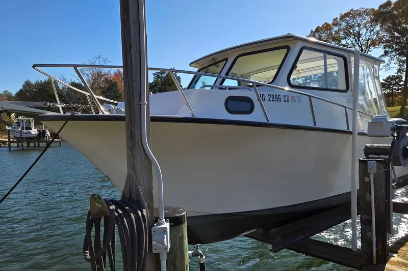 Slide: The Image of 2015 May-Craft 2550 Pilot XL boat docked on a sunny day. - 8