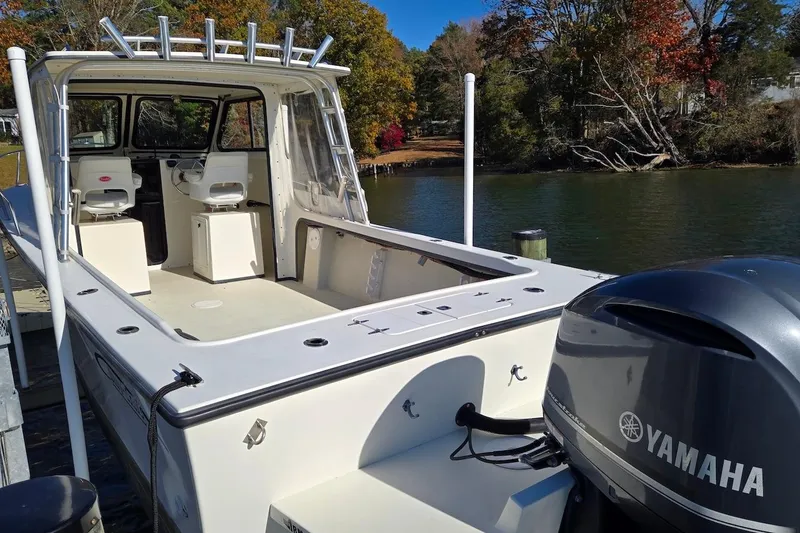 Slide: The Image of 2015 May-Craft 2550 Pilot XL boat with Yamaha engine docked by a scenic river. - 9