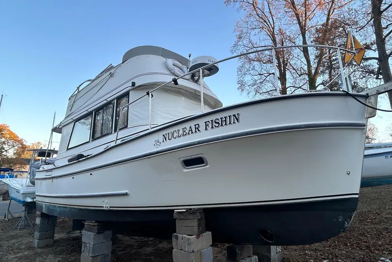 The Image of 1999 Camano 31 Troll boat named "Nuclear Fishin" on blocks, side view. - 0