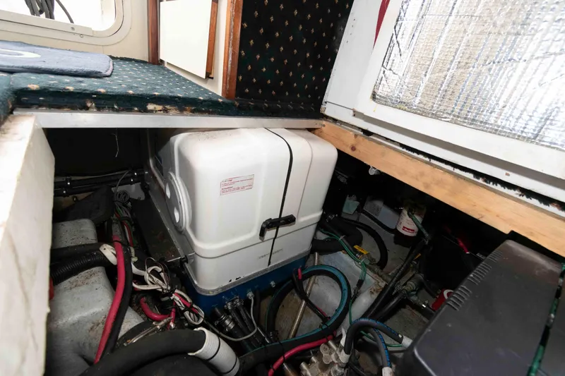 Slide: The Image of Engine compartment of 1999 Camano 31 Troll boat, showing mechanical components and wiring. - 15