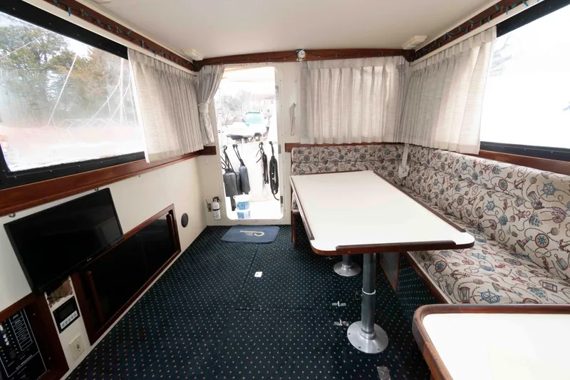 Slide: The Image of Interior of 1999 Camano 31 Troll boat with dining area and patterned seating. - 6