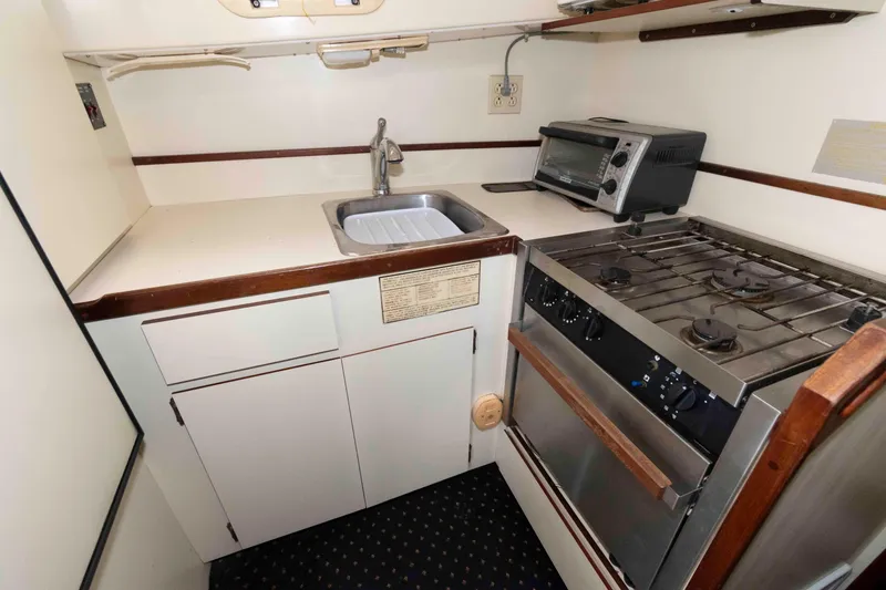 Slide: The Image of Compact kitchen in 1999 Camano 31 Troll boat with stove, sink, and toaster oven. - 7